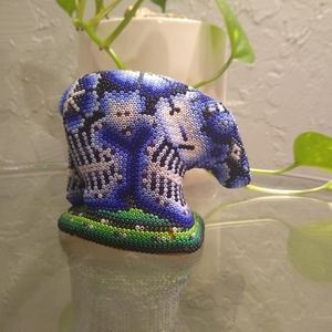 This is a wooden bear with beads